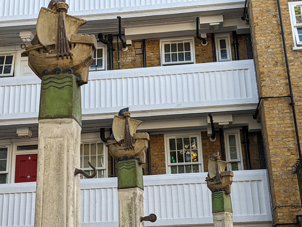 Finials designed by Gilbert Bayes, on the top of washing line posts St Michael's flats, Aldenham Street, Somers Town